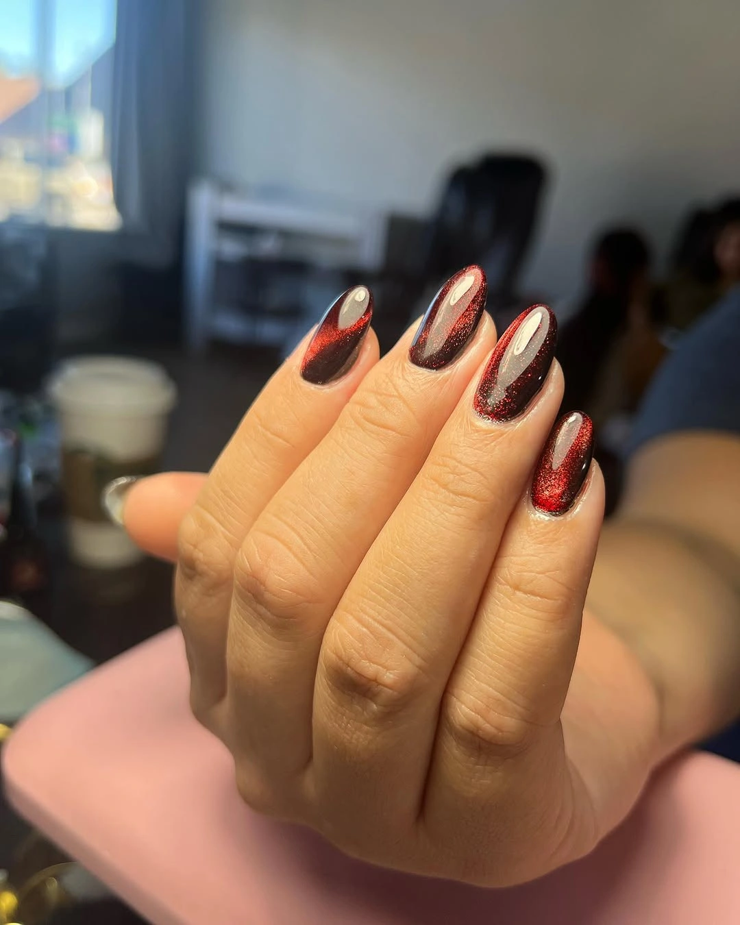 Dark almond nails with reflective red pointed French tip edges