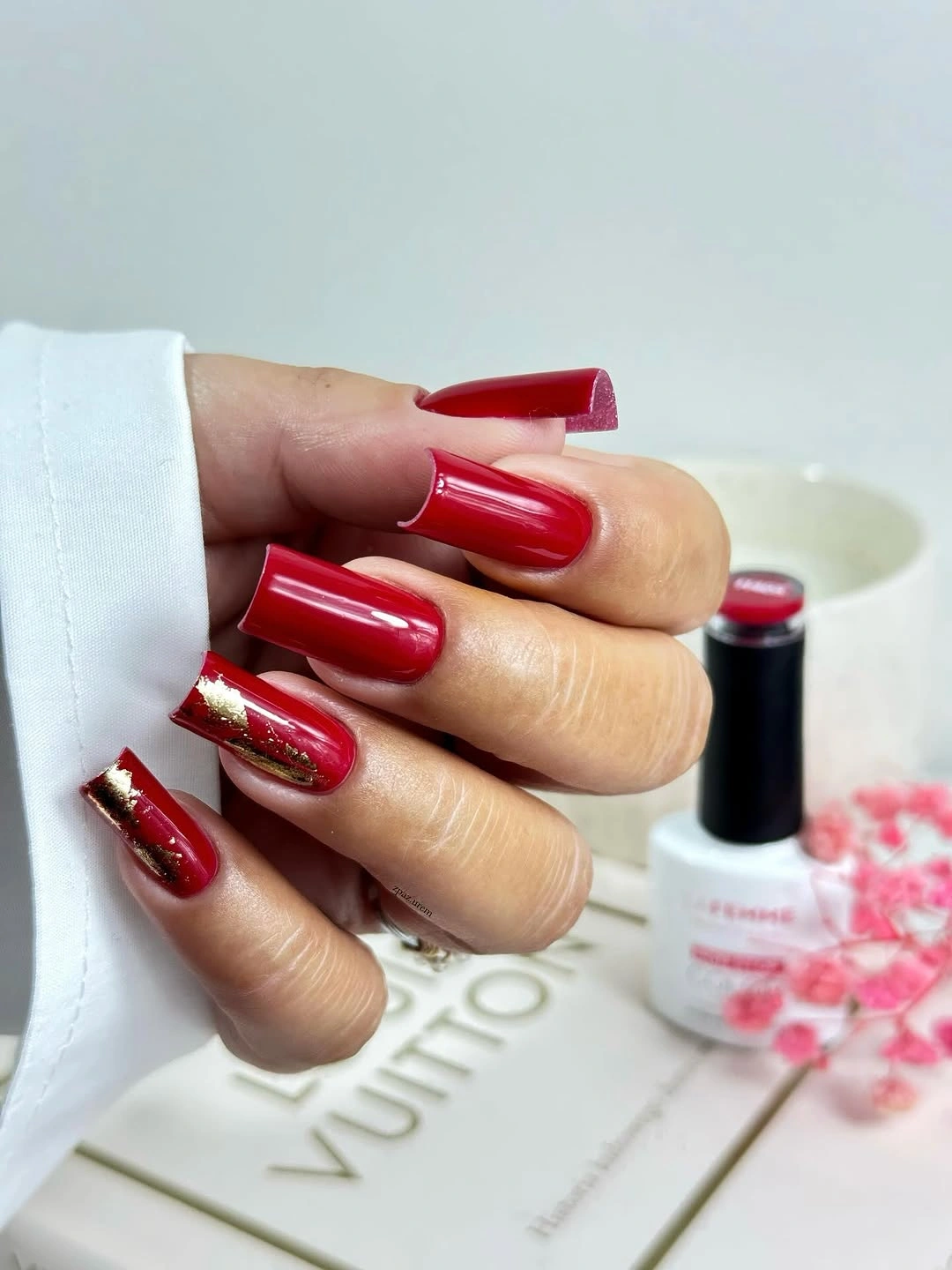 Long glossy red square nails with one small gold edge accent