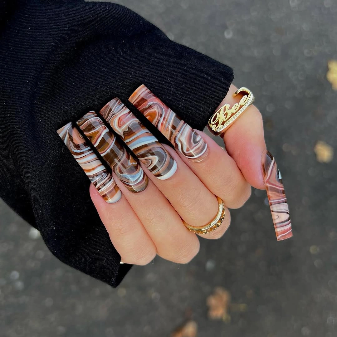 Long square nails with brown cream white and taupe abstract ribbon swirls