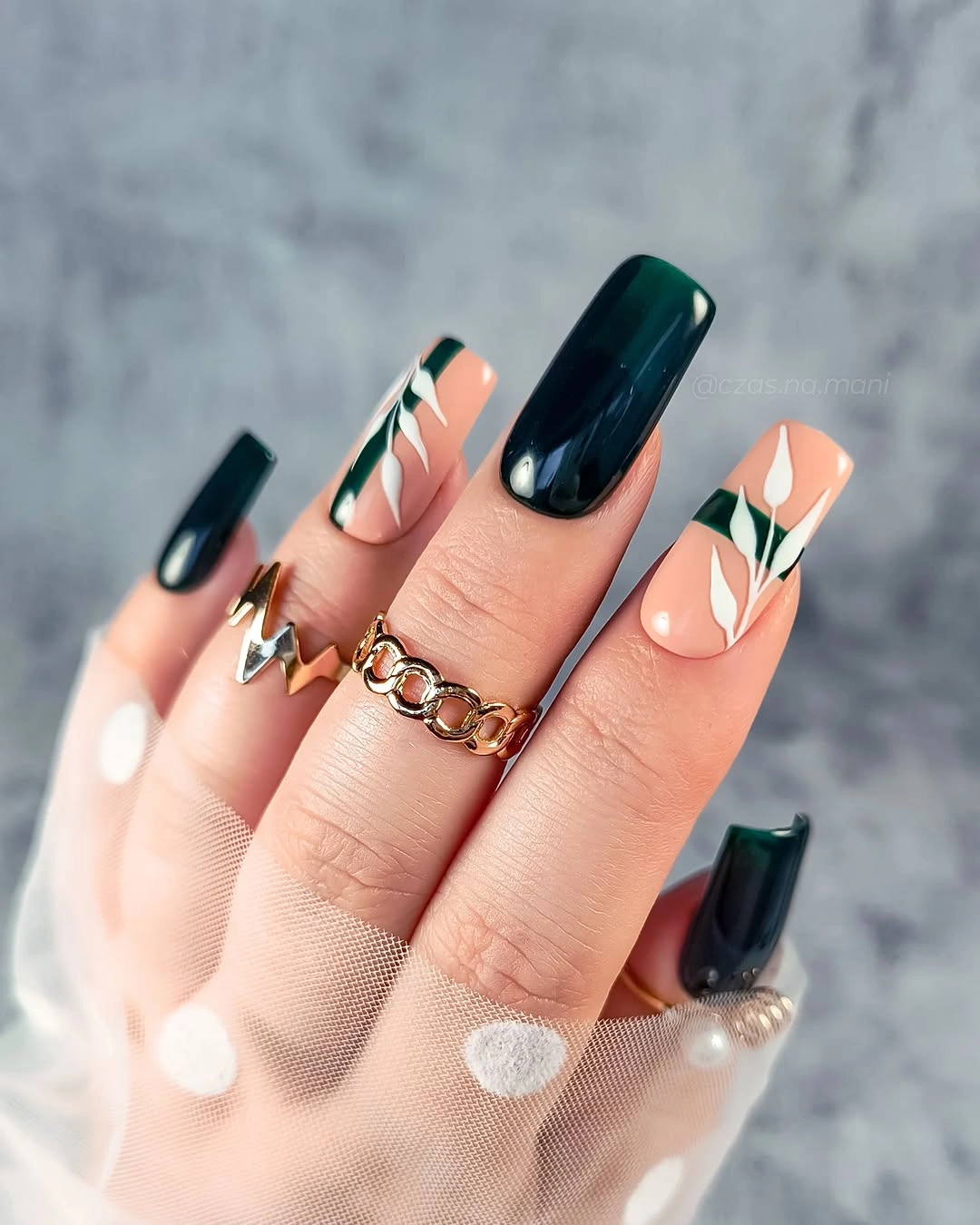 Dark teal square nails with pale peach botanical leaf accent art