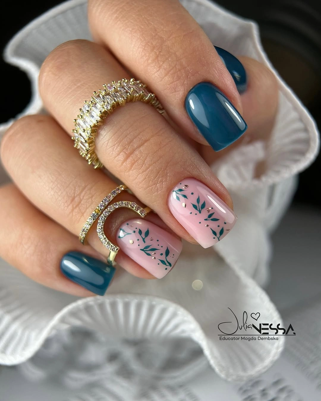 Deep teal square nails with pale pink accents and fine teal leaves