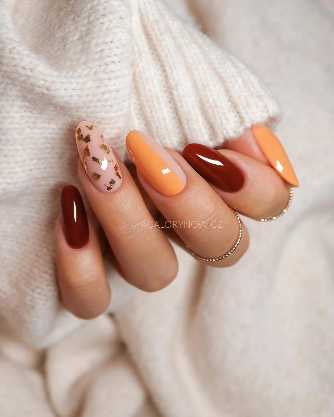 Orange brown and pale pink almond nails with leaf-like accent detail