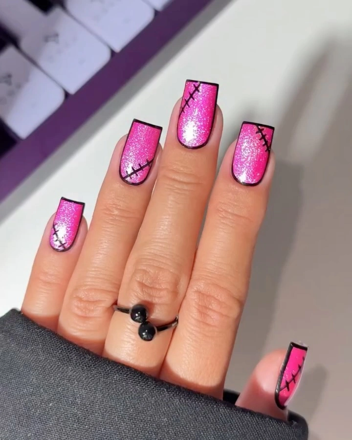 Hot pink shimmer square nails with black stitched border details