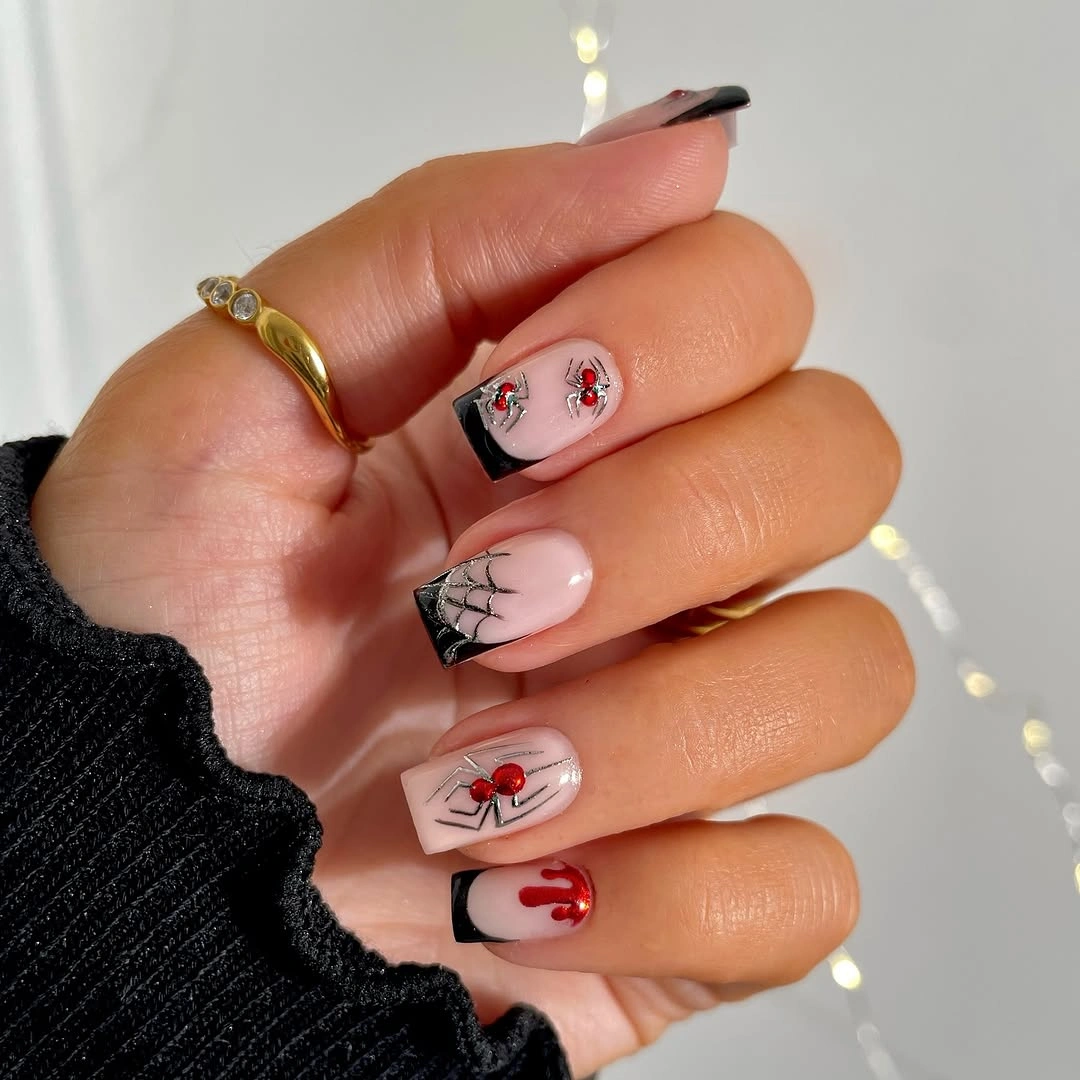 Pink nails with black French tips spiders webs and red accents