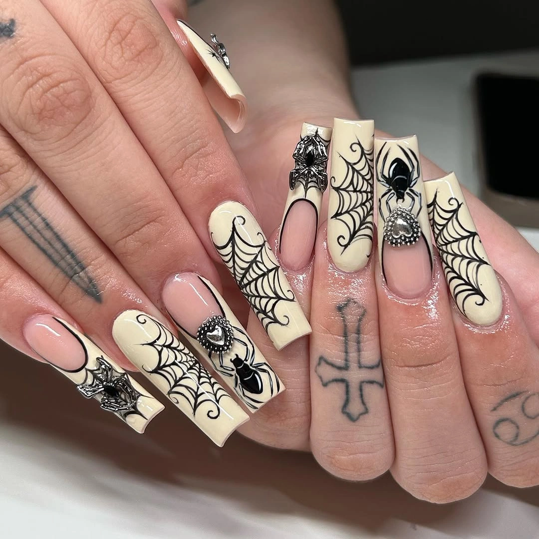 Long cream square nails with black spiderwebs and gothic accents