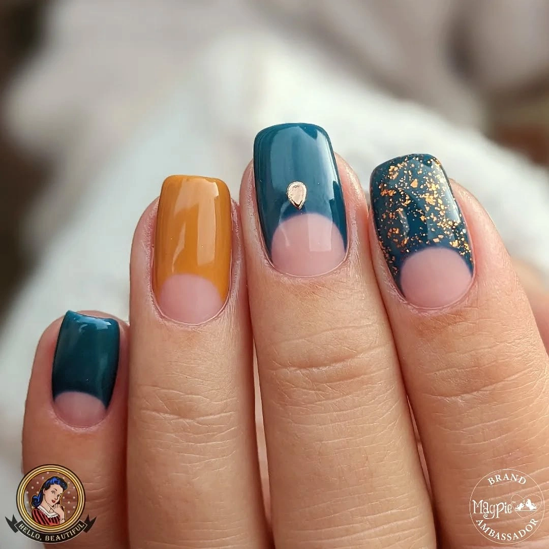 Short nails with teal mustard blocks pink negative space and gold speckles