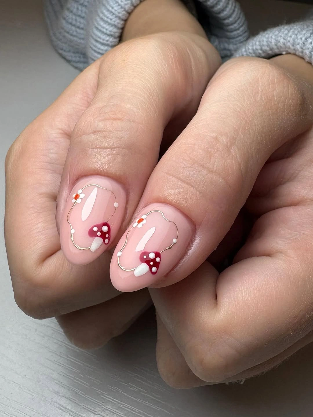 Short pale pink nails with red mushroom caps white dots and curves