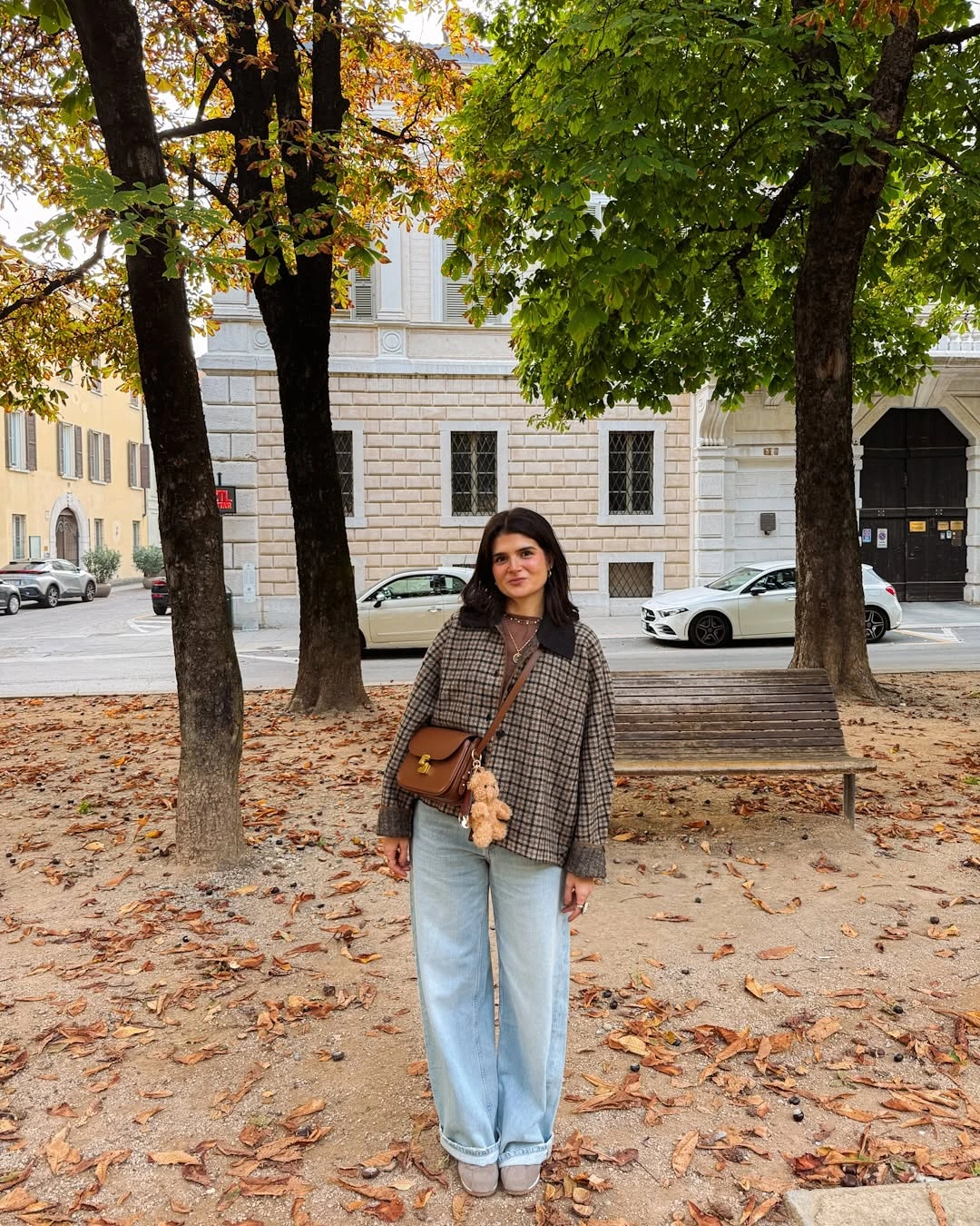Brown checked jacket with light blue relaxed jeans and shoulder bag