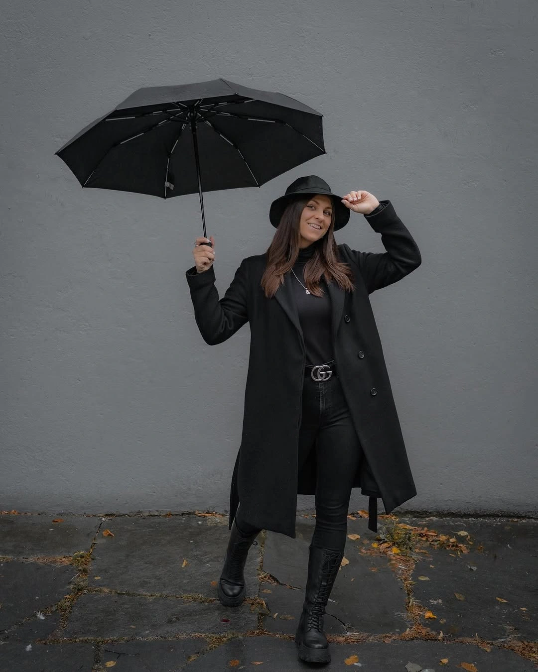 Long black coat wide-brim hat and tall black boots