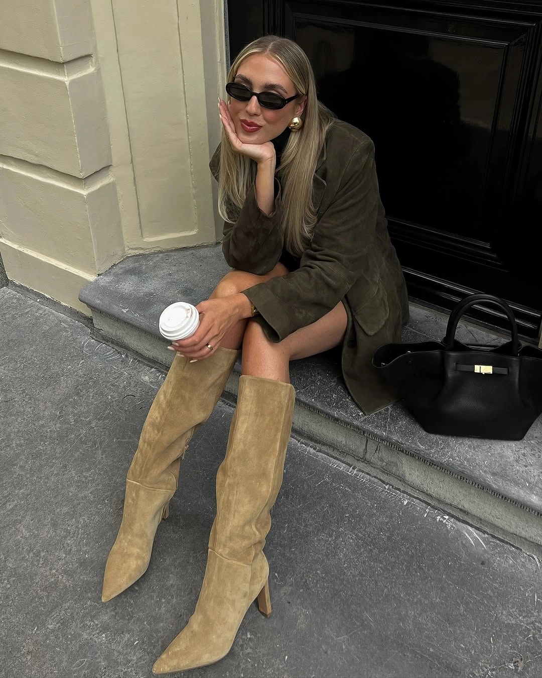Olive blazer with knee-high tan boots and black structured bag