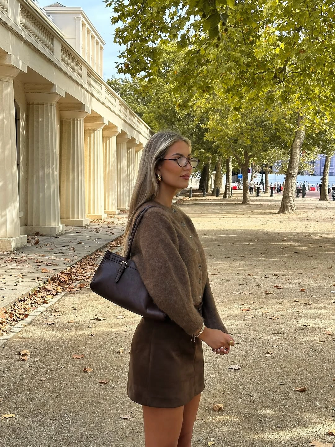 Brown fuzzy sweater with cocoa mini skirt and dark shoulder bag