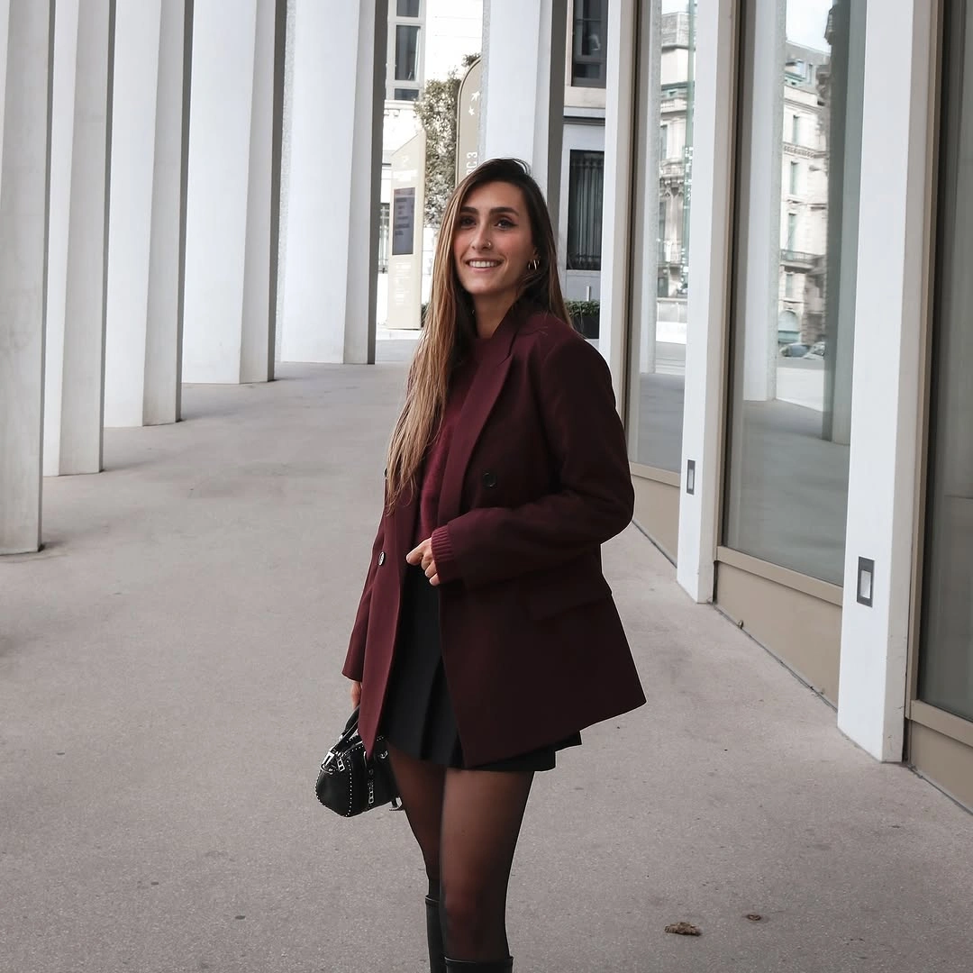 Burgundy blazer over black mini dress with sheer tights