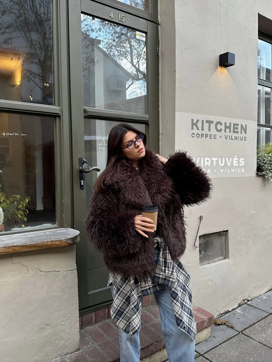 Textured brown coat with plaid mini and light jeans