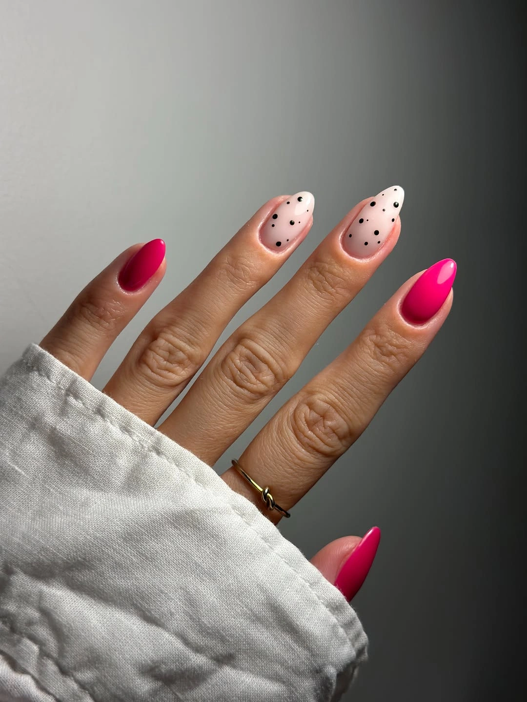 Fuchsia almond nails with blush black dotted accent nails