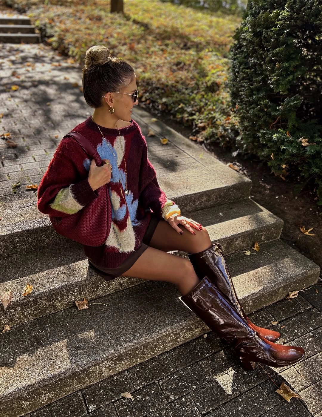 Burgundy patterned cardigan with tights and tall brown boots