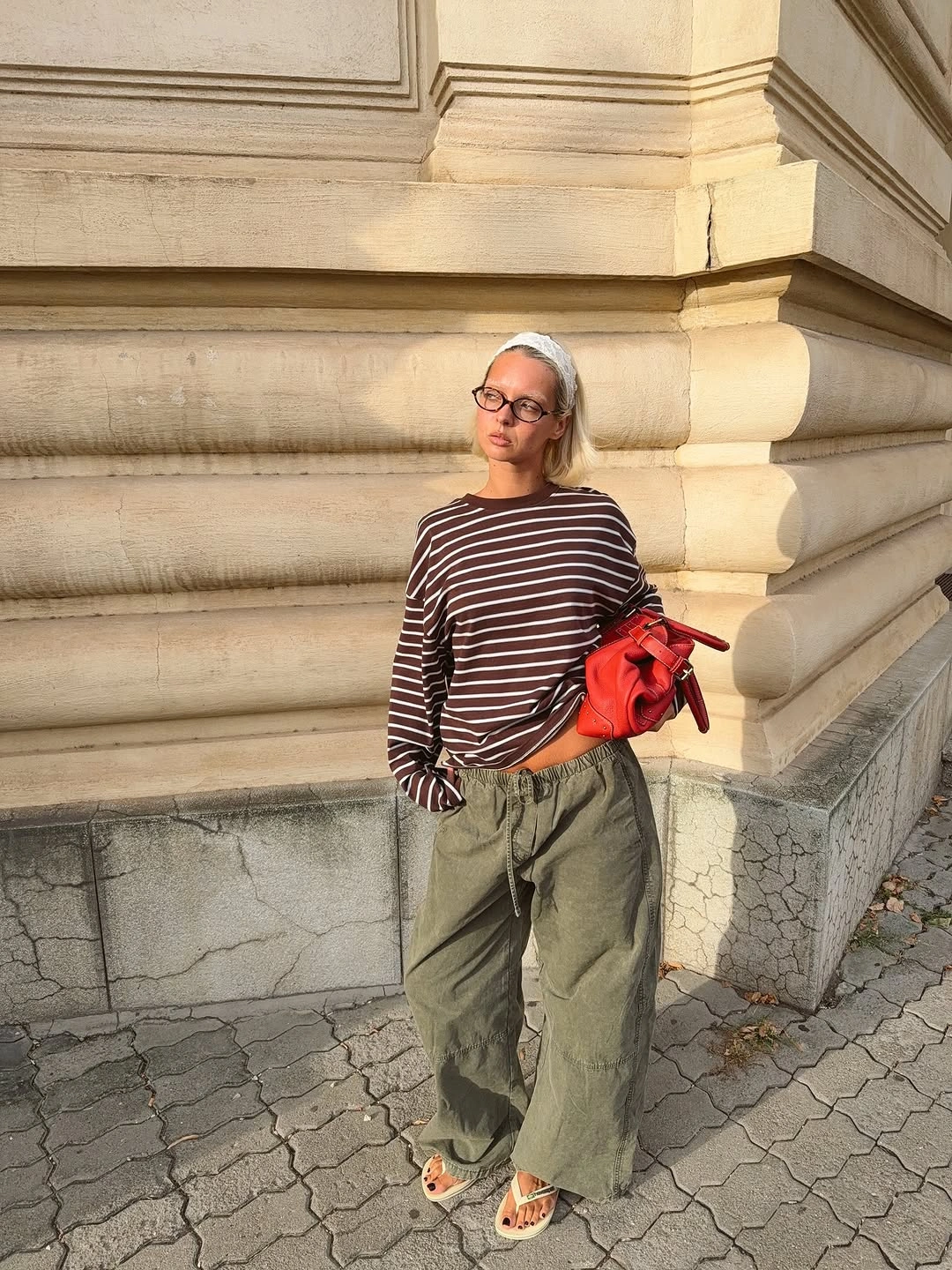 Striped top olive wide trousers and red bag