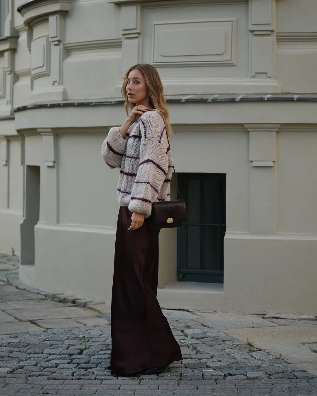 Striped cardigan with long brown skirt and small bag