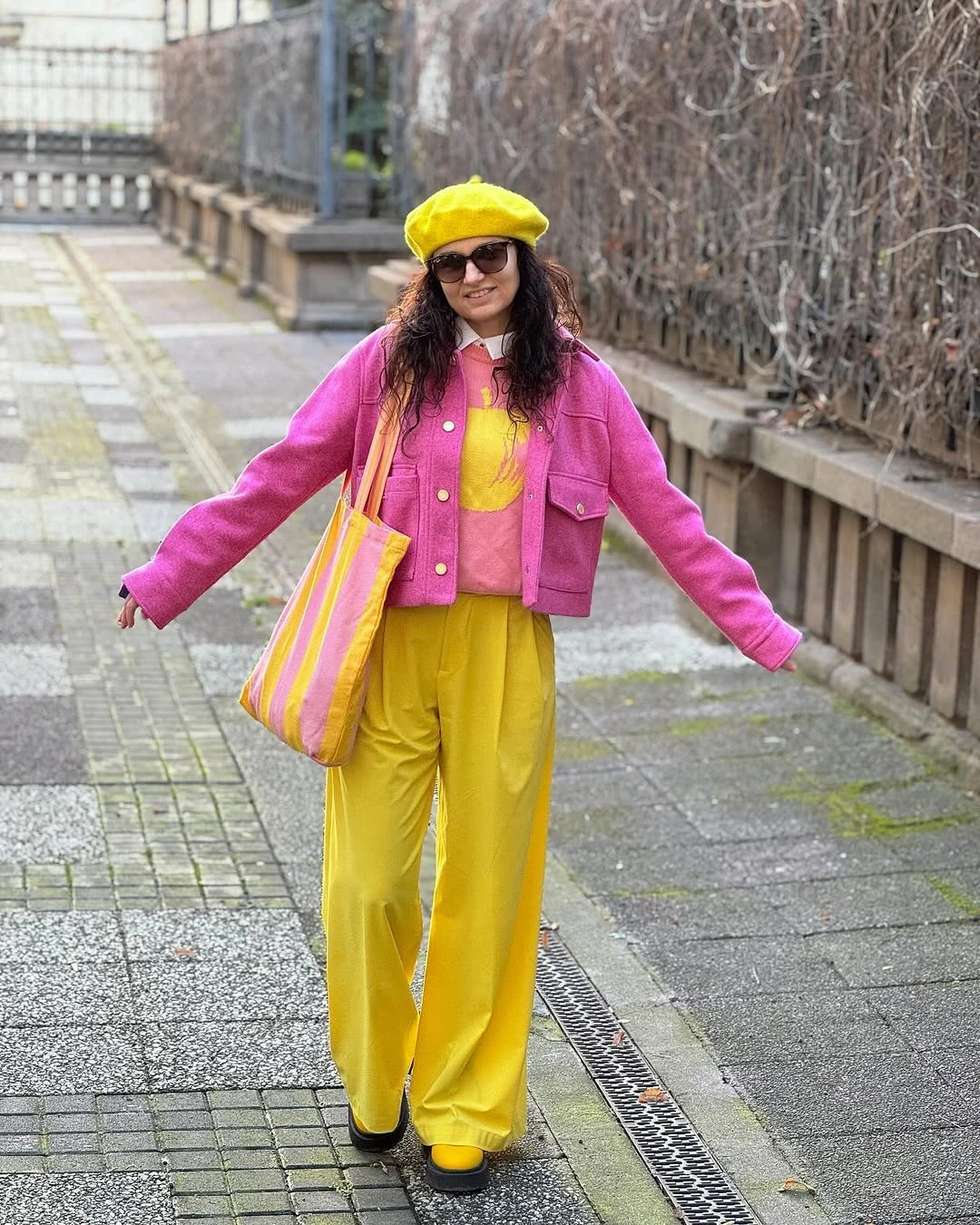 Hot pink jacket with yellow cap and wide trousers