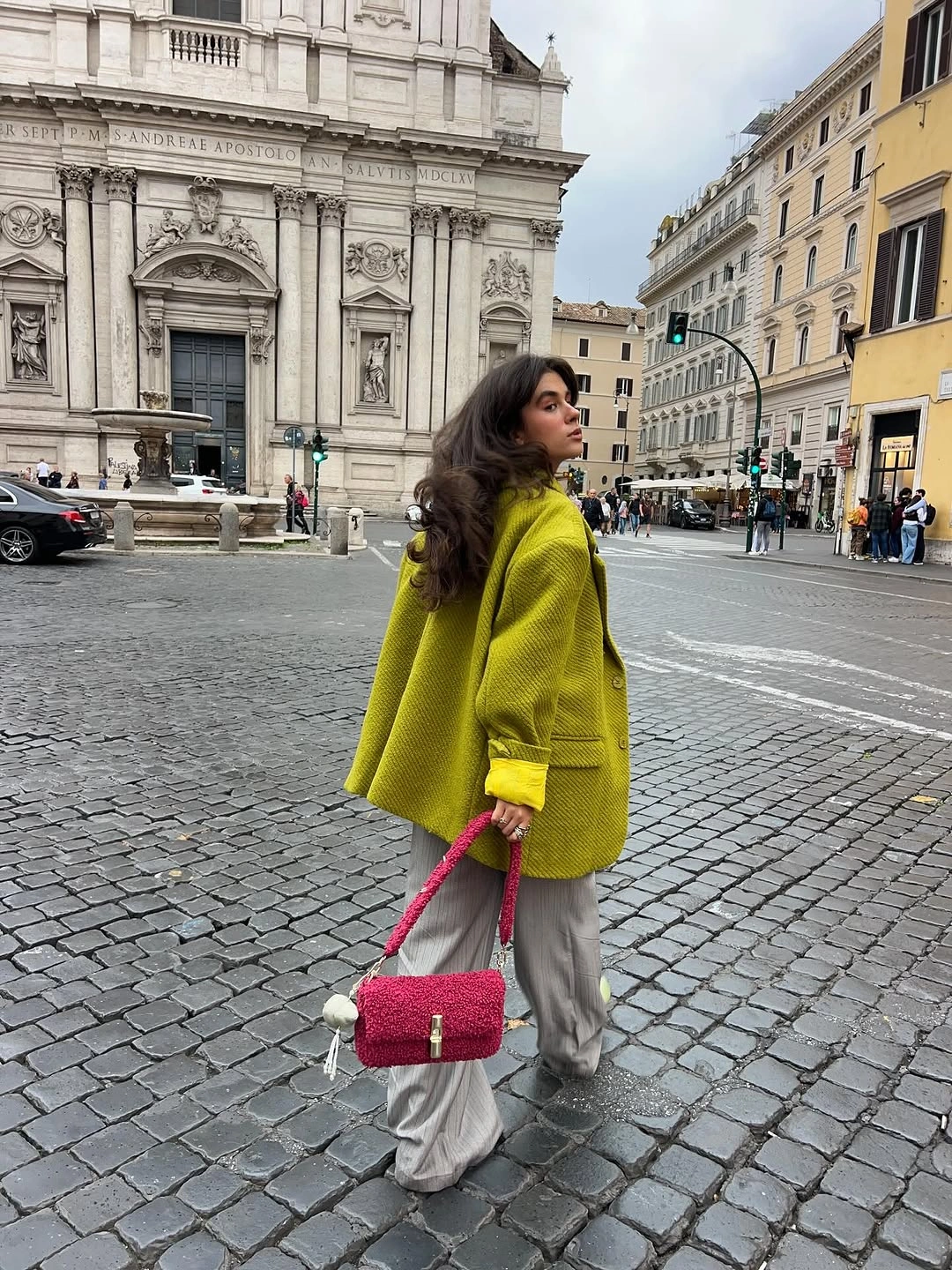 Lime jacket gray wide trousers and pink shoulder bag