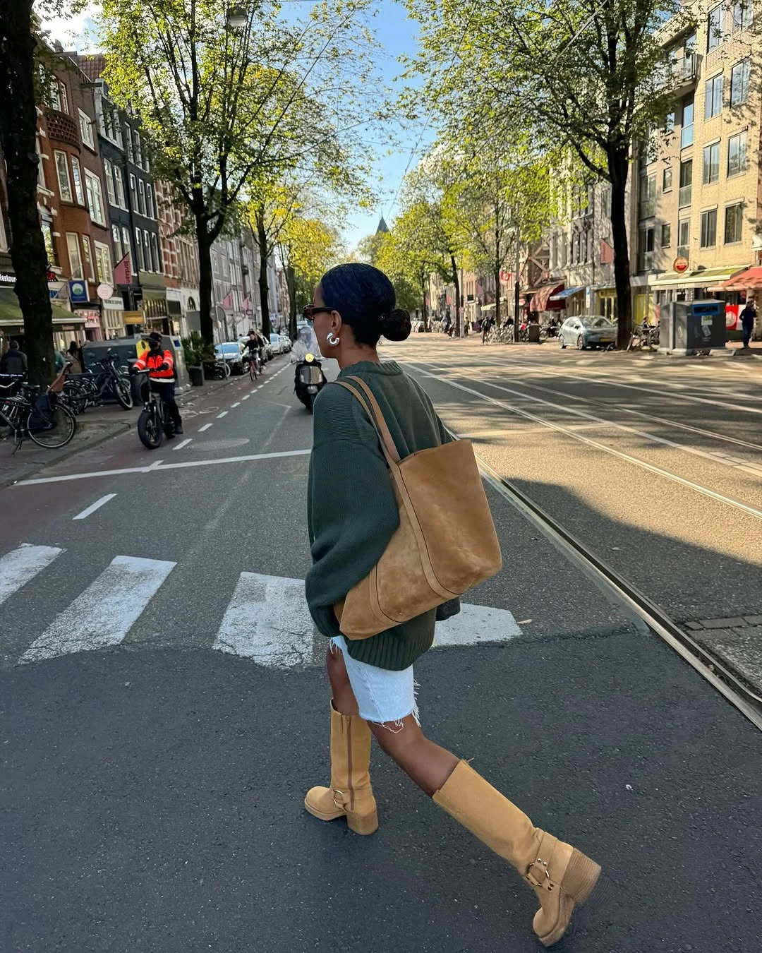 Green sweater white shorts tan boots and tote