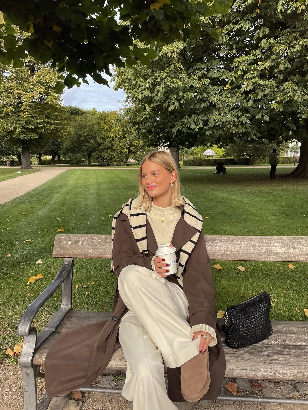 Brown jacket over cream layers and wide trousers