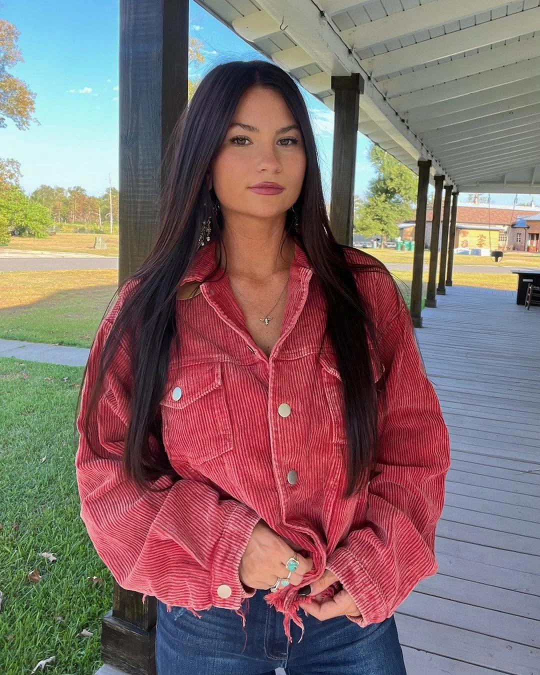 Bright red utility jacket with dark jeans