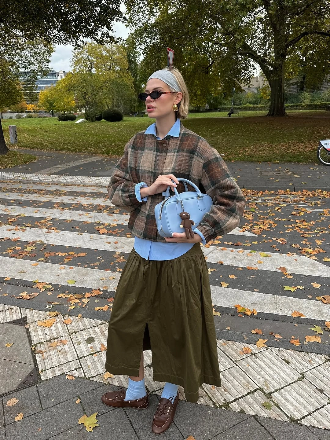 Plaid layer olive trousers and pale blue bag