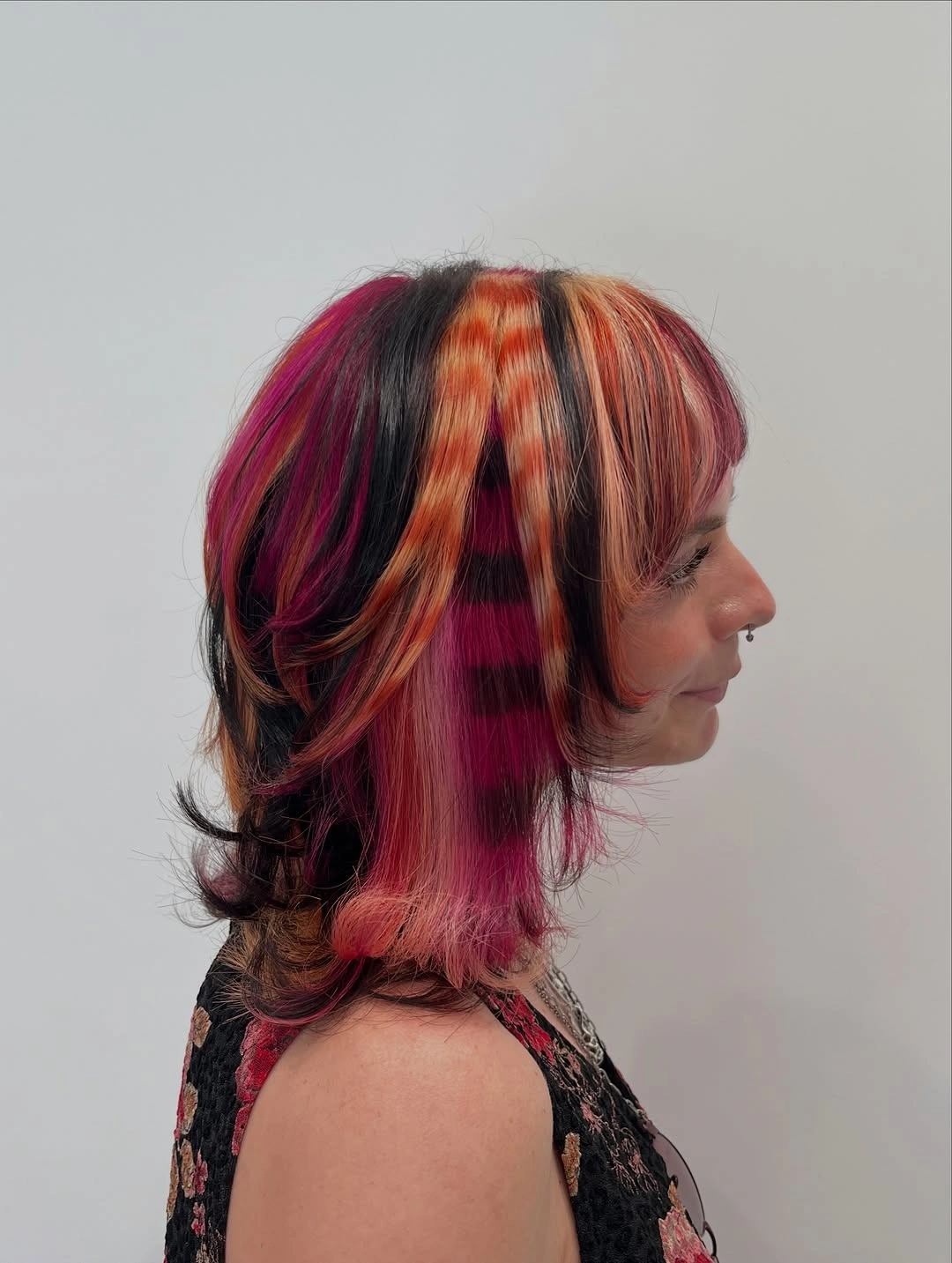 Layered medium hair with red orange and pink panels