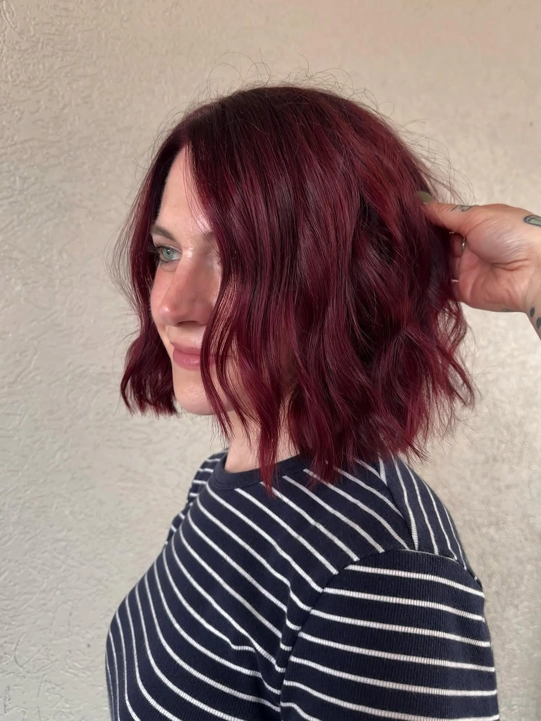 Rounded plum burgundy bob with soft waves