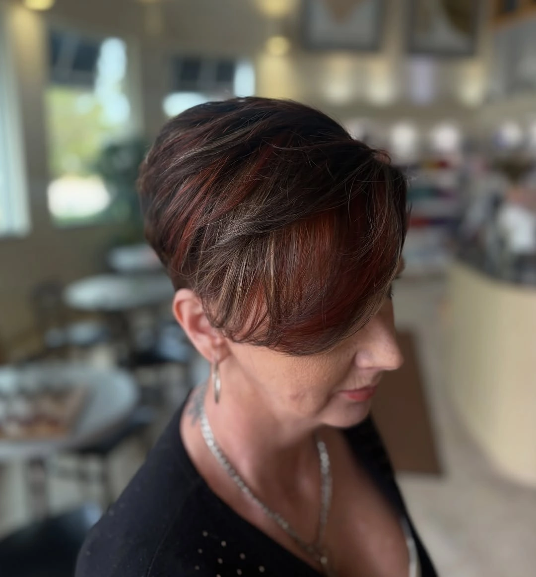 Short brown swept style with a copper front accent