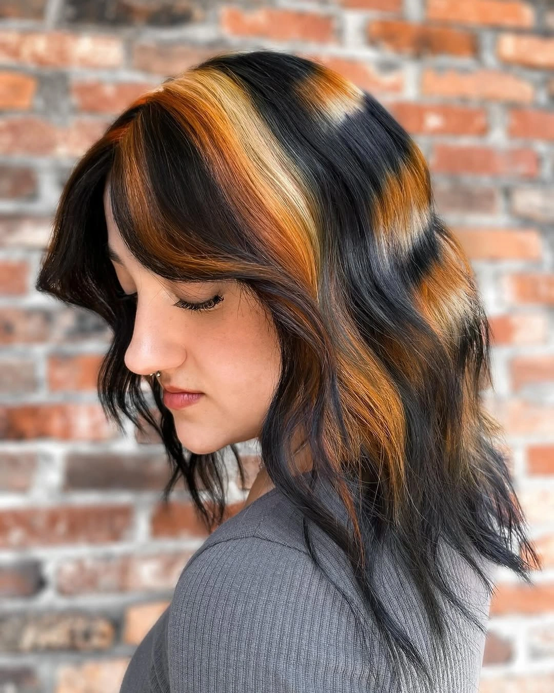 Dark waves with broad copper face-framing panels