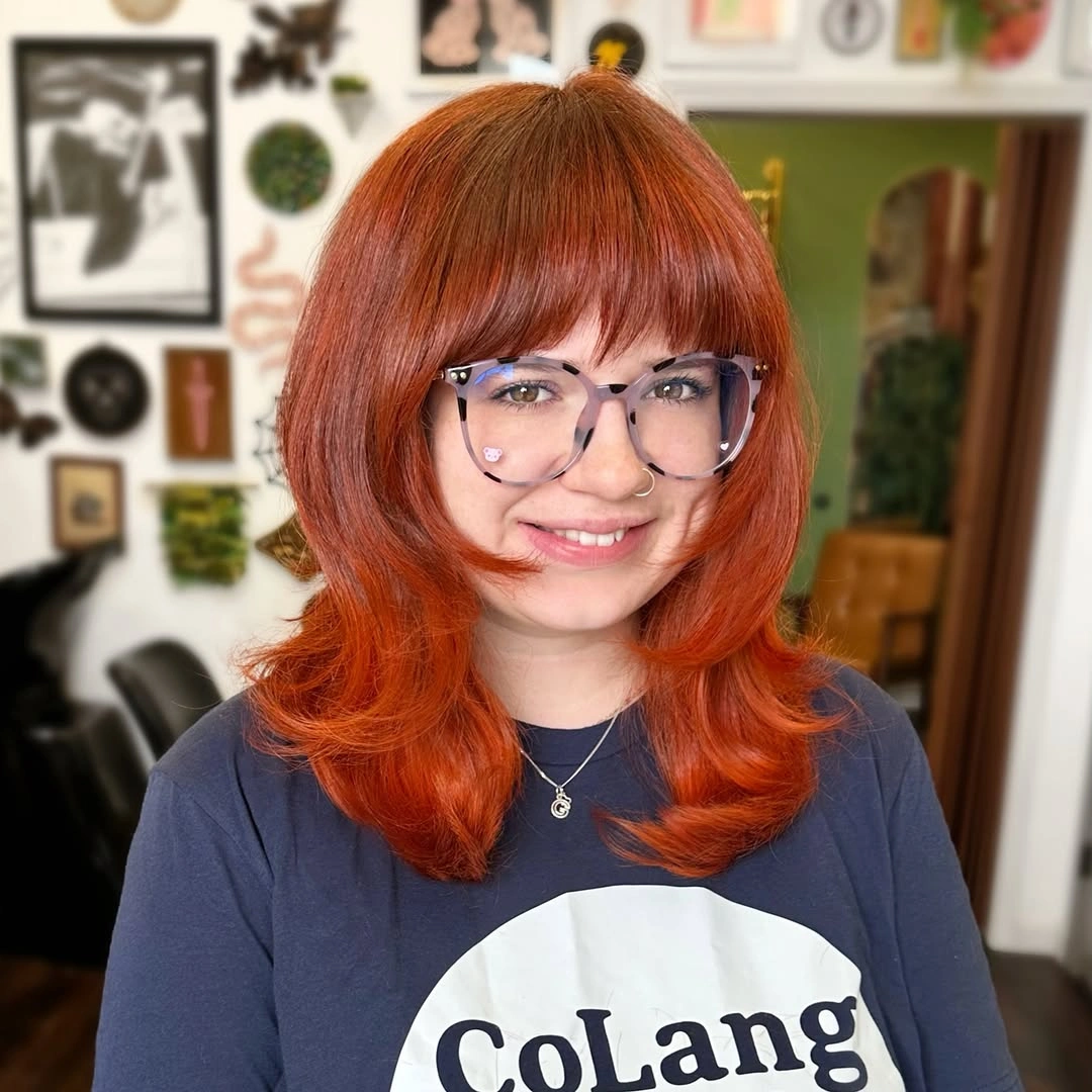 Bright copper red bob with blunt bangs