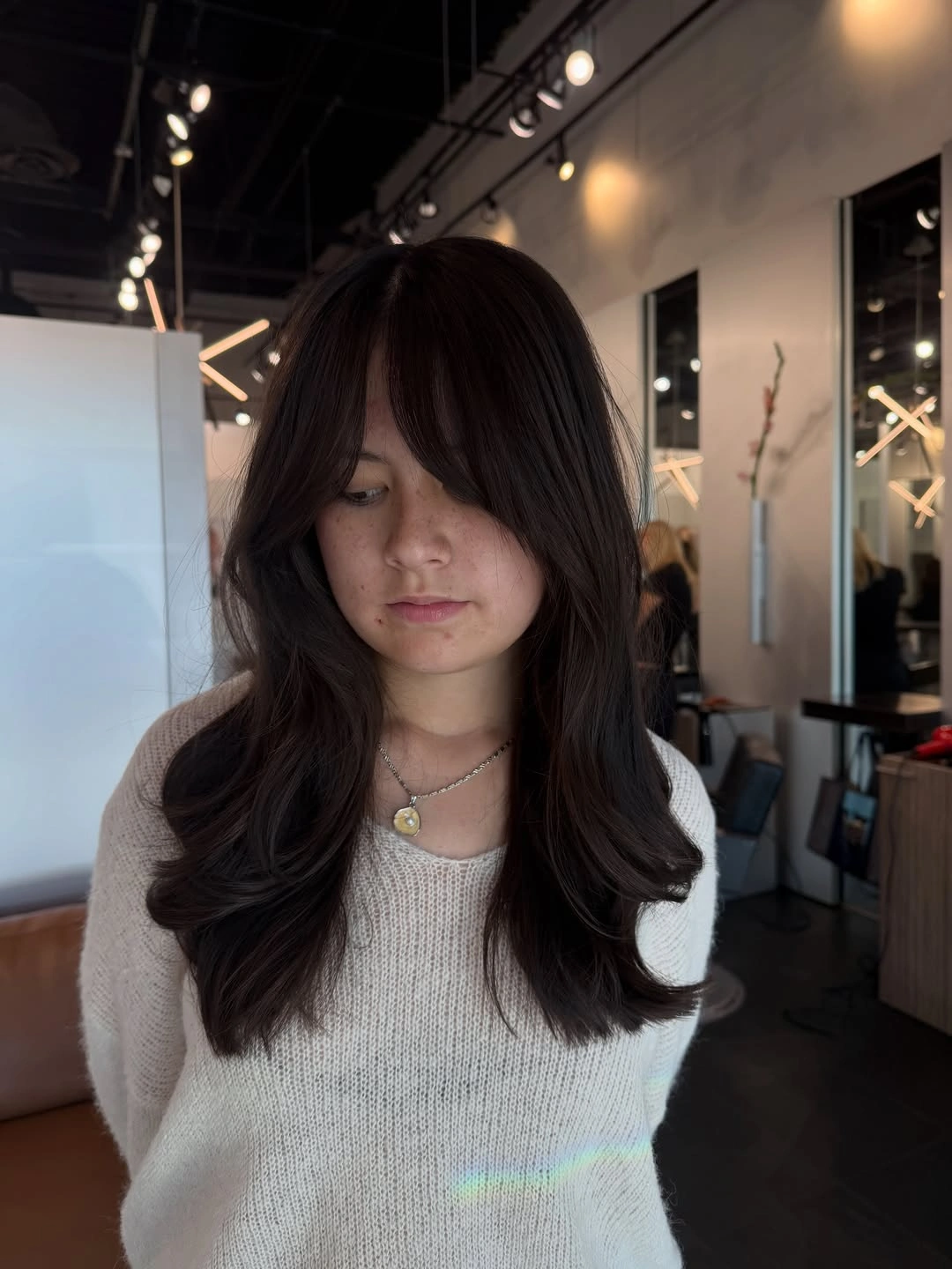 Long dark brunette layers with curtain bangs