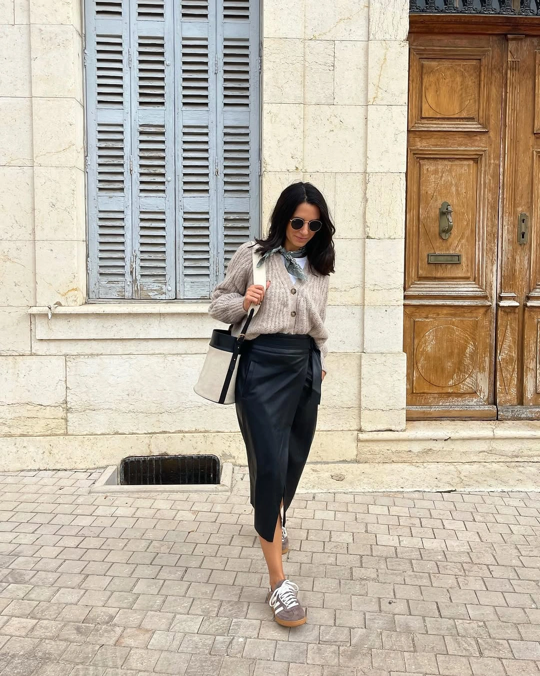 Taupe knit top with black midi skirt and black bag