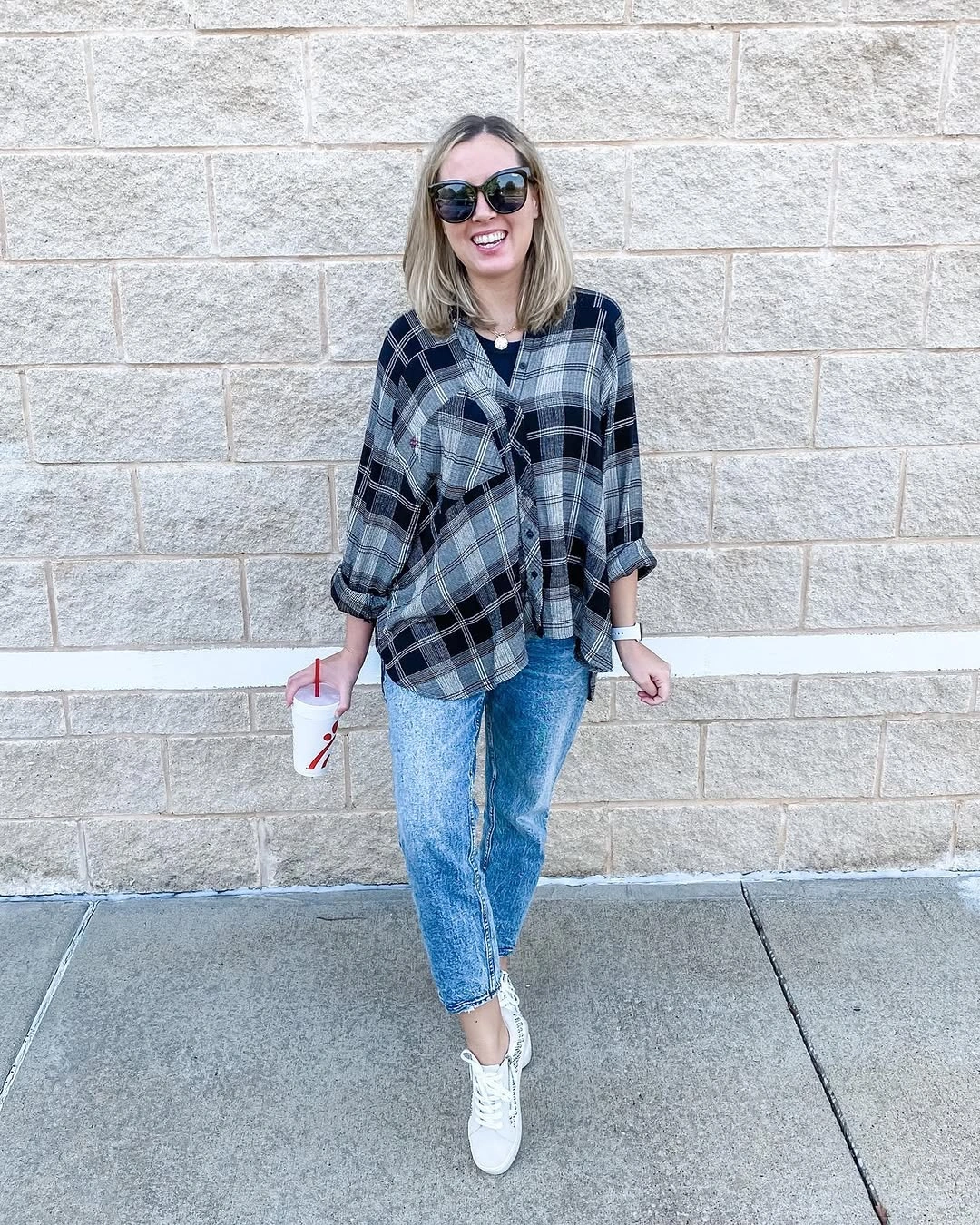 Blue plaid overshirt with jeans and white sneakers