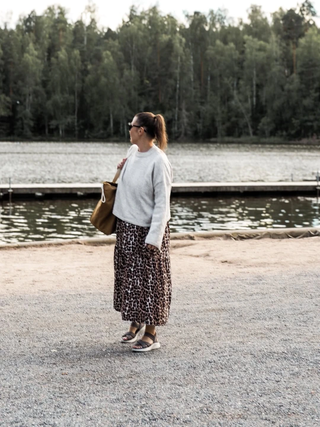 Gray sweater with long patterned midi skirt and sneakers