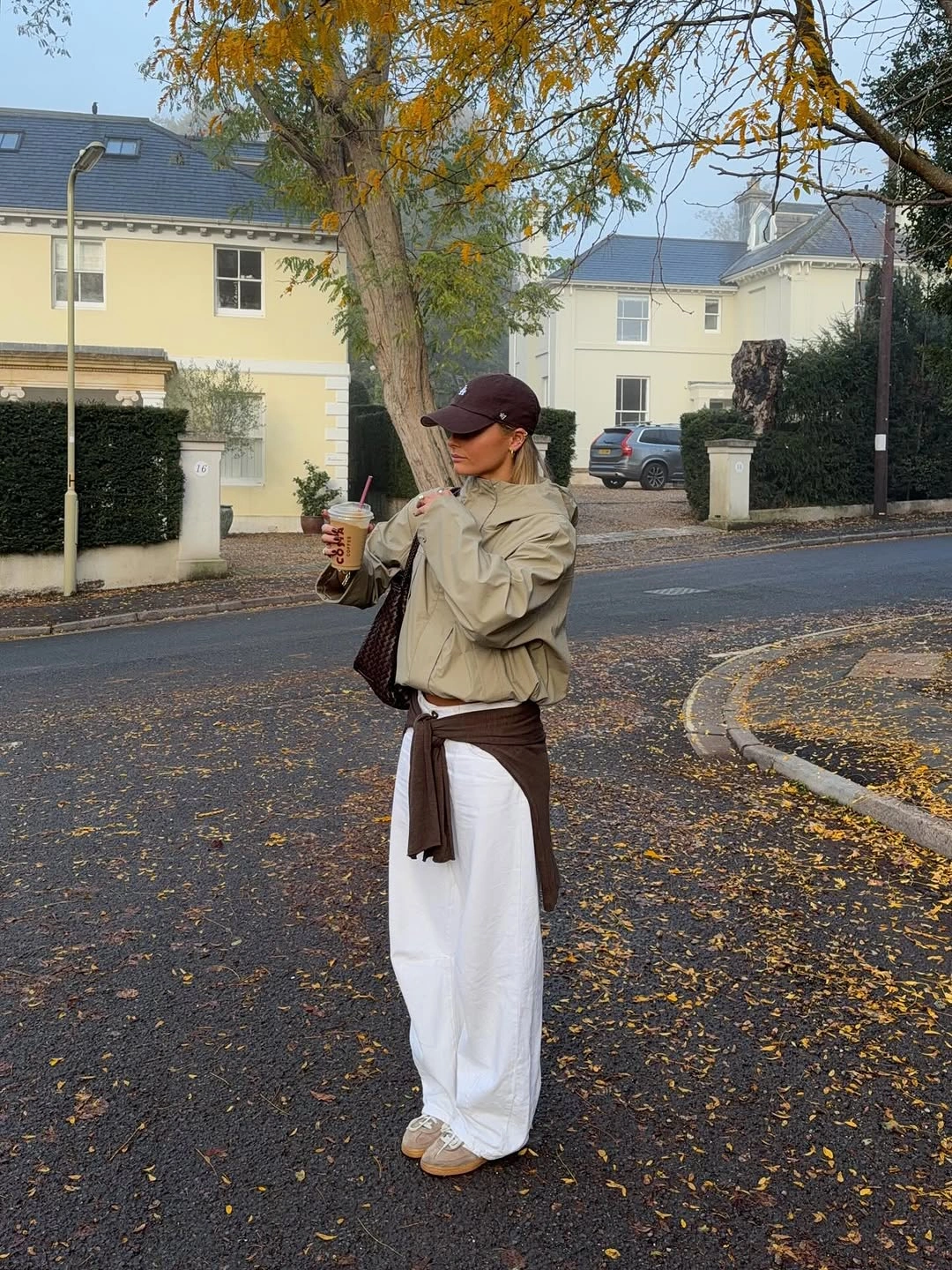 Pale jacket white trousers cap and brown crossbody
