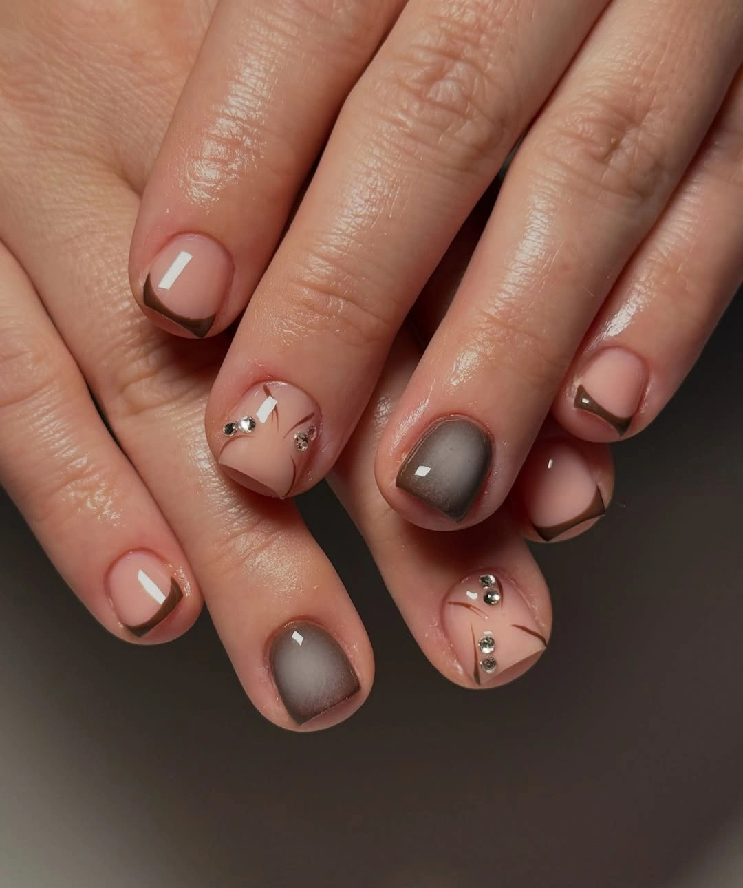 short neutral nails with taupe rose gray and tiny accents