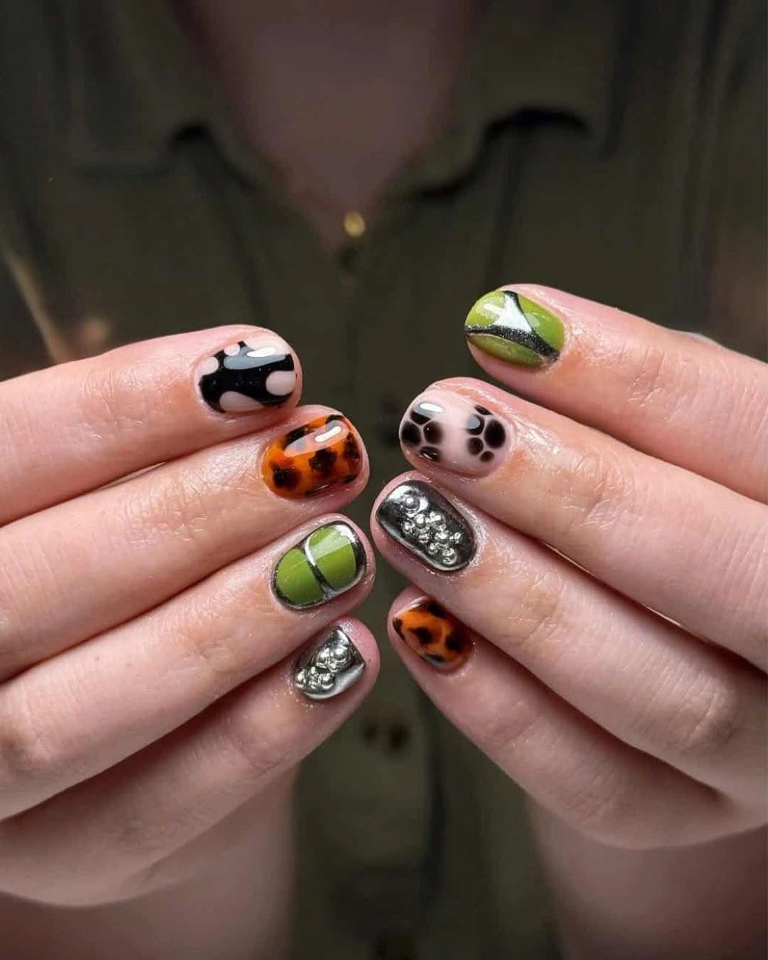 short mismatched nails with lime orange pink black and sparkle accents