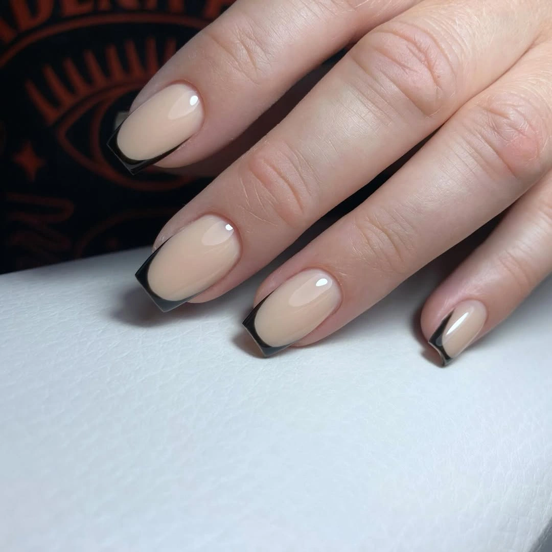 short almond nails with thin black French tips and one line accent