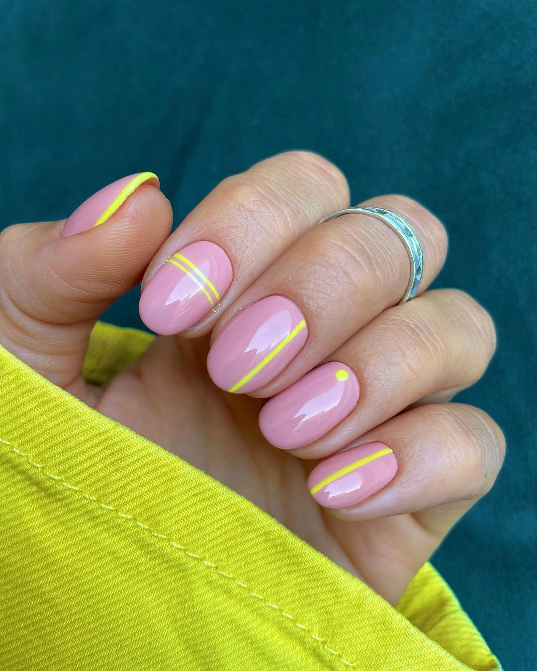 short pink nails with double neon yellow curved tips