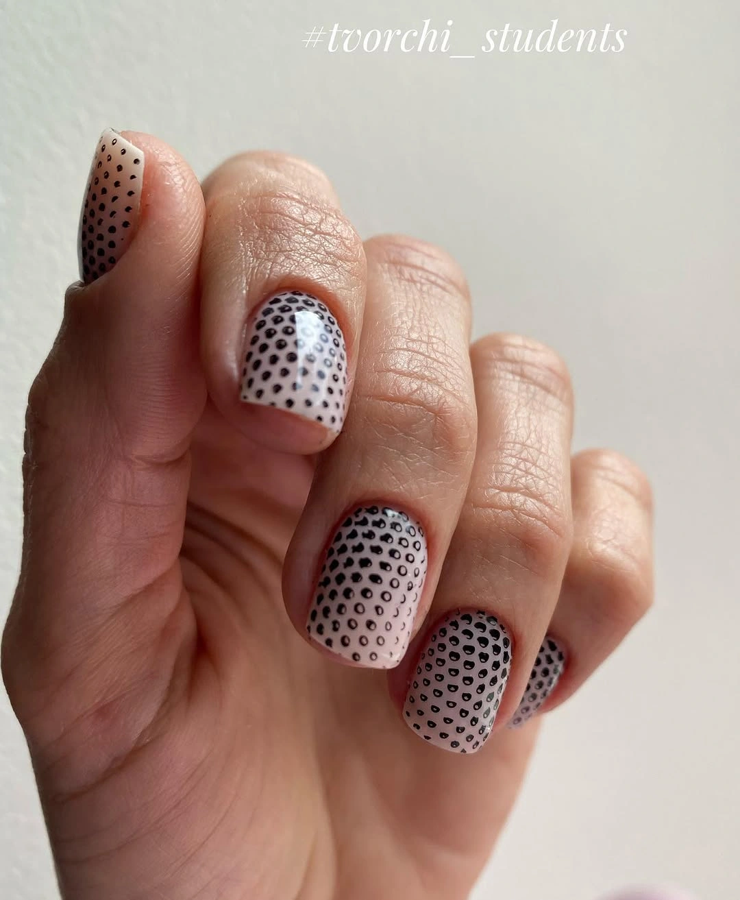 short light nails with dense black polka dot pattern