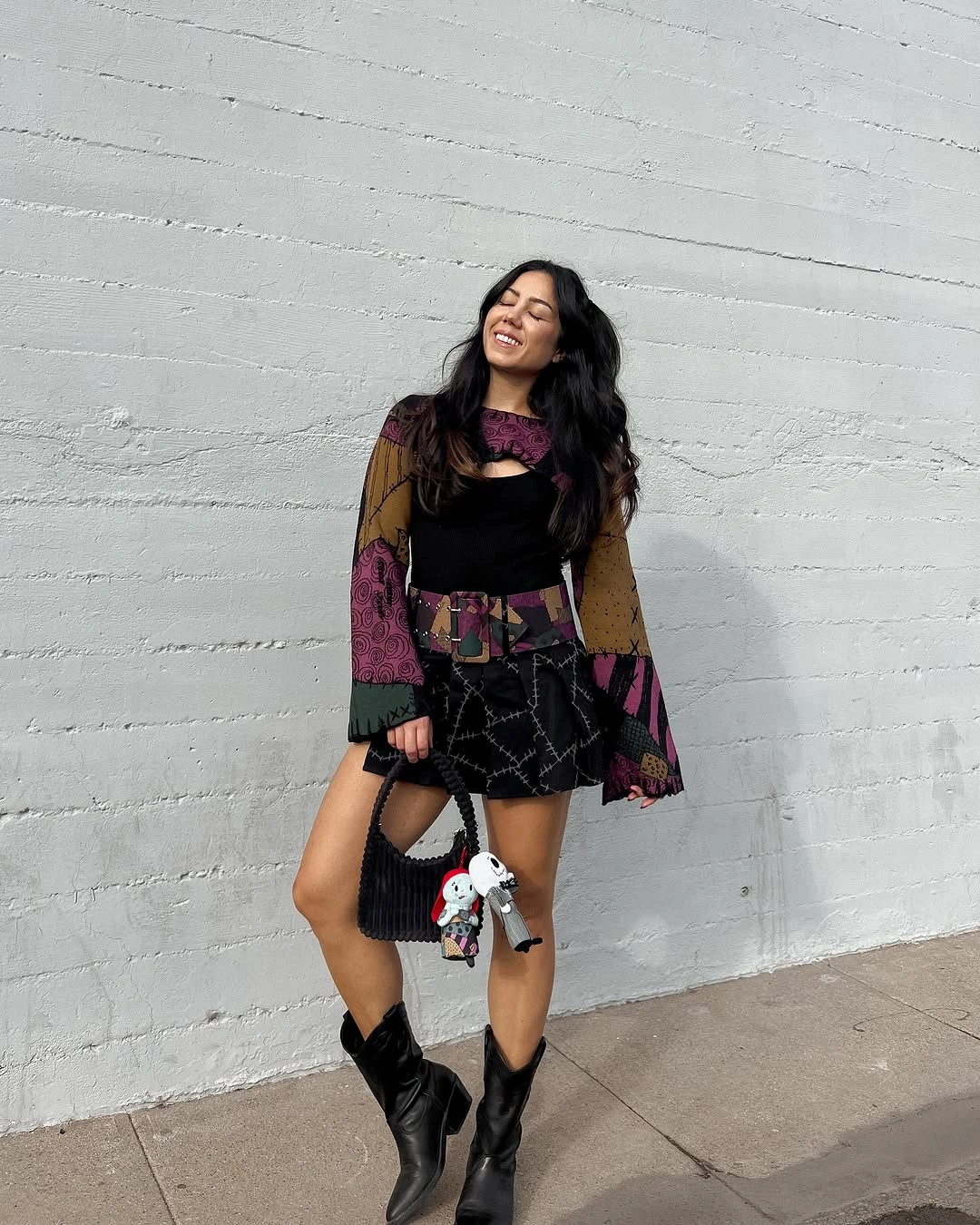 Black mini dress with sheer multicolor patchwork sleeves lace tights ankle boots and plush bag