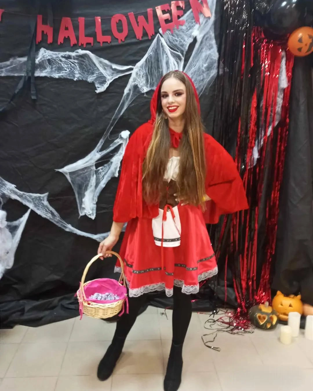 Bright red hooded cape dress with black tights ankle boots and small basket