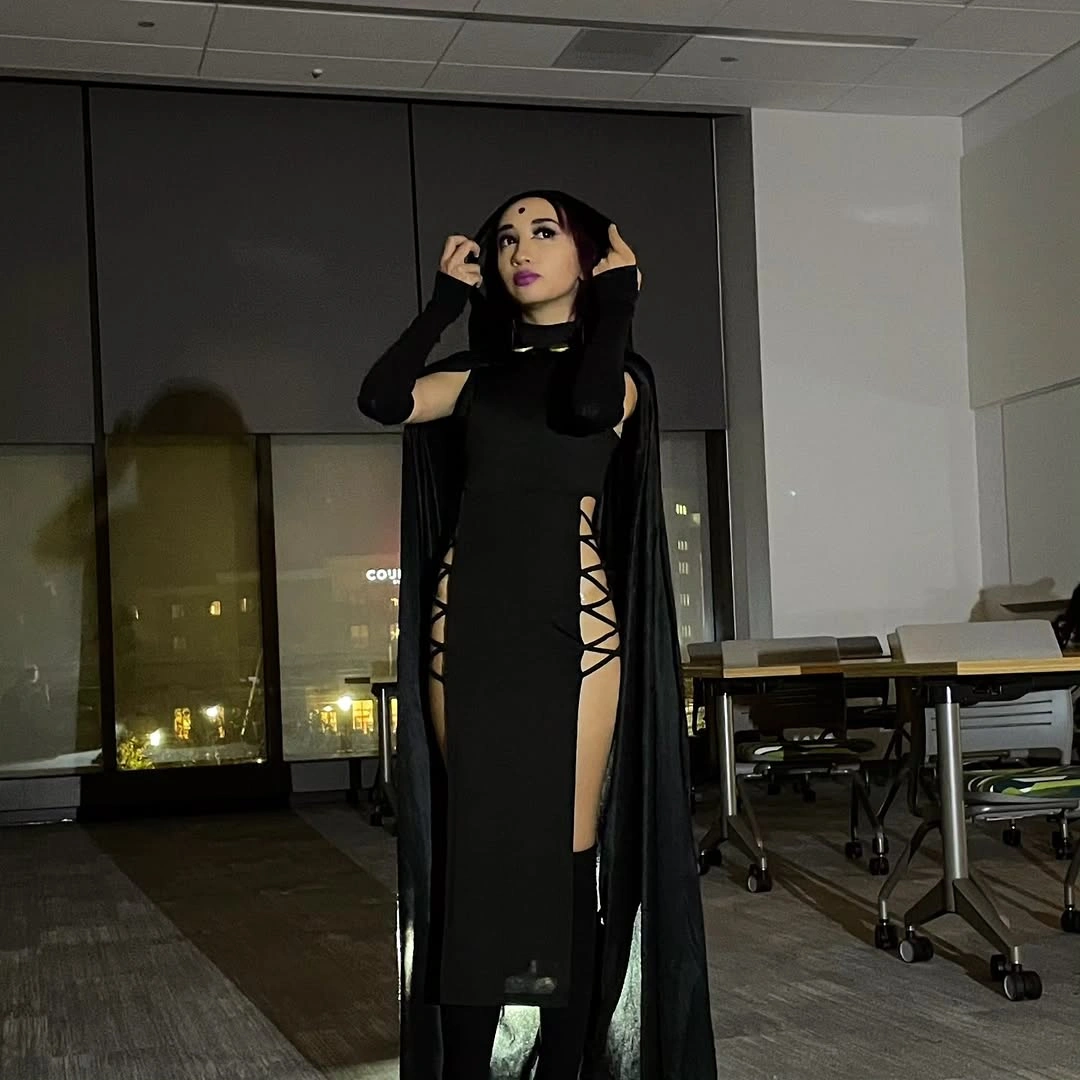 Black high-slit maxi dress with lace-up side openings long black gloves and black boots