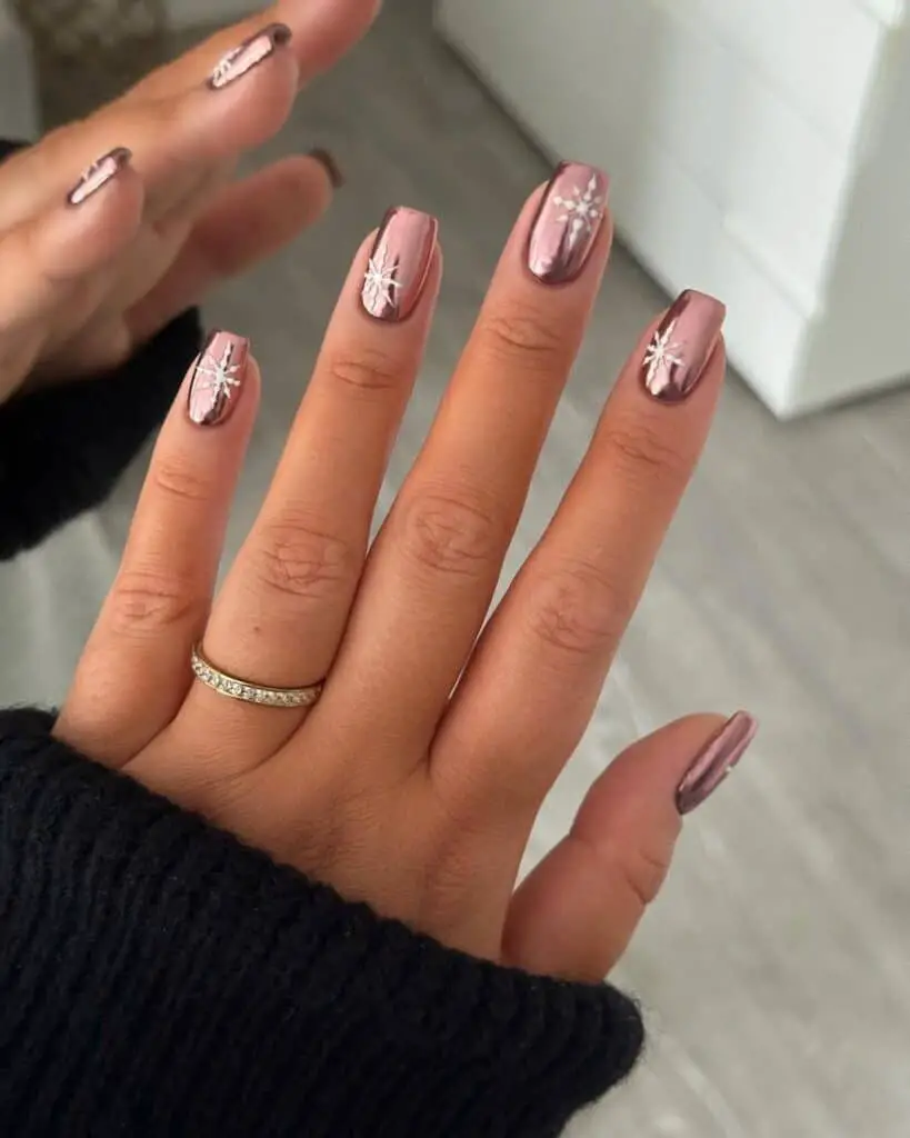 Rose Gold Chrome with White Snowflakes Rose Gold Chrome with White Snowflakes — Winter Nail Colors for Women Over 50
