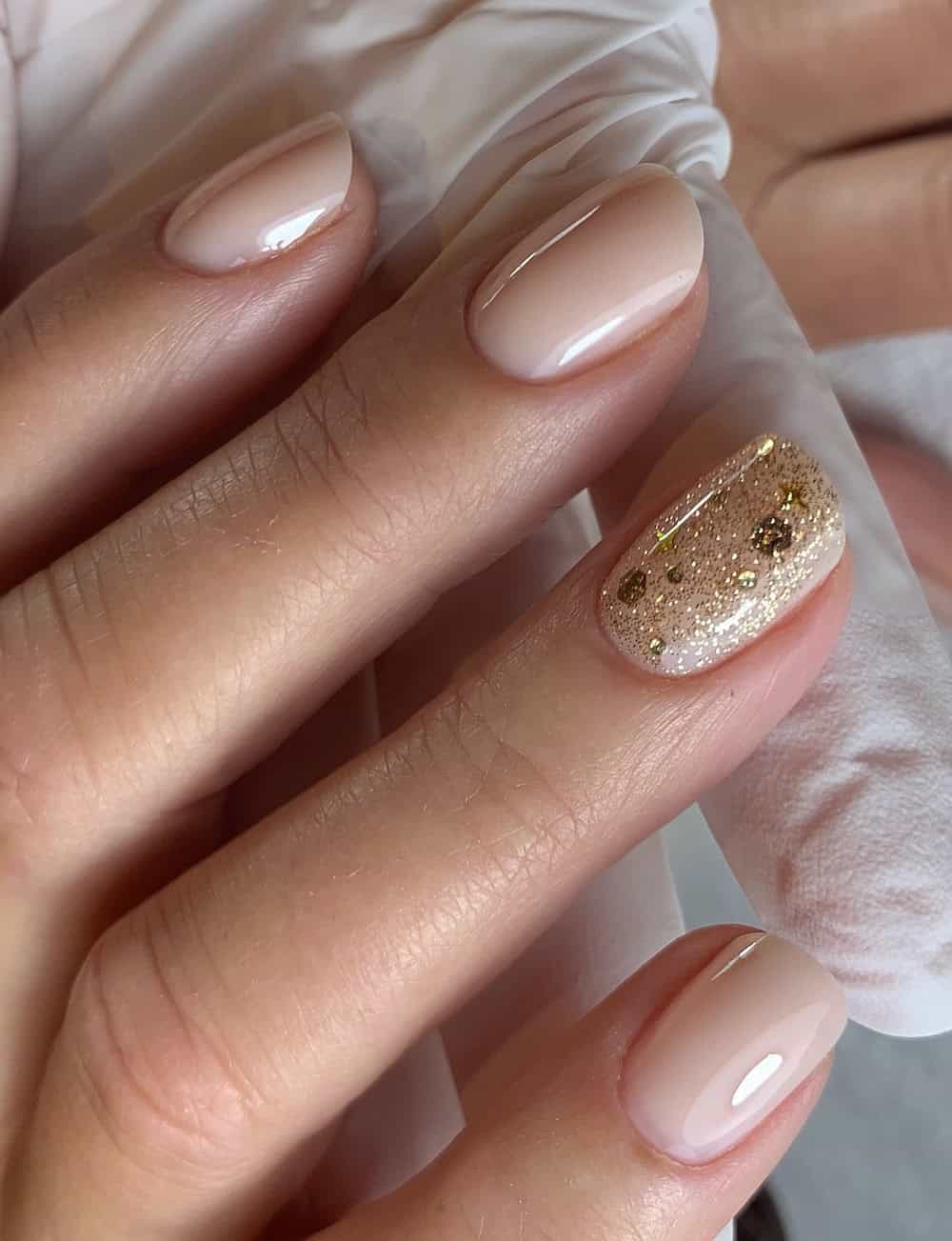 Glossy With Scattered Gold Glitter Visual Idea Glossy With Scattered Gold Glitter Visual Idea — Winter Nude Nails