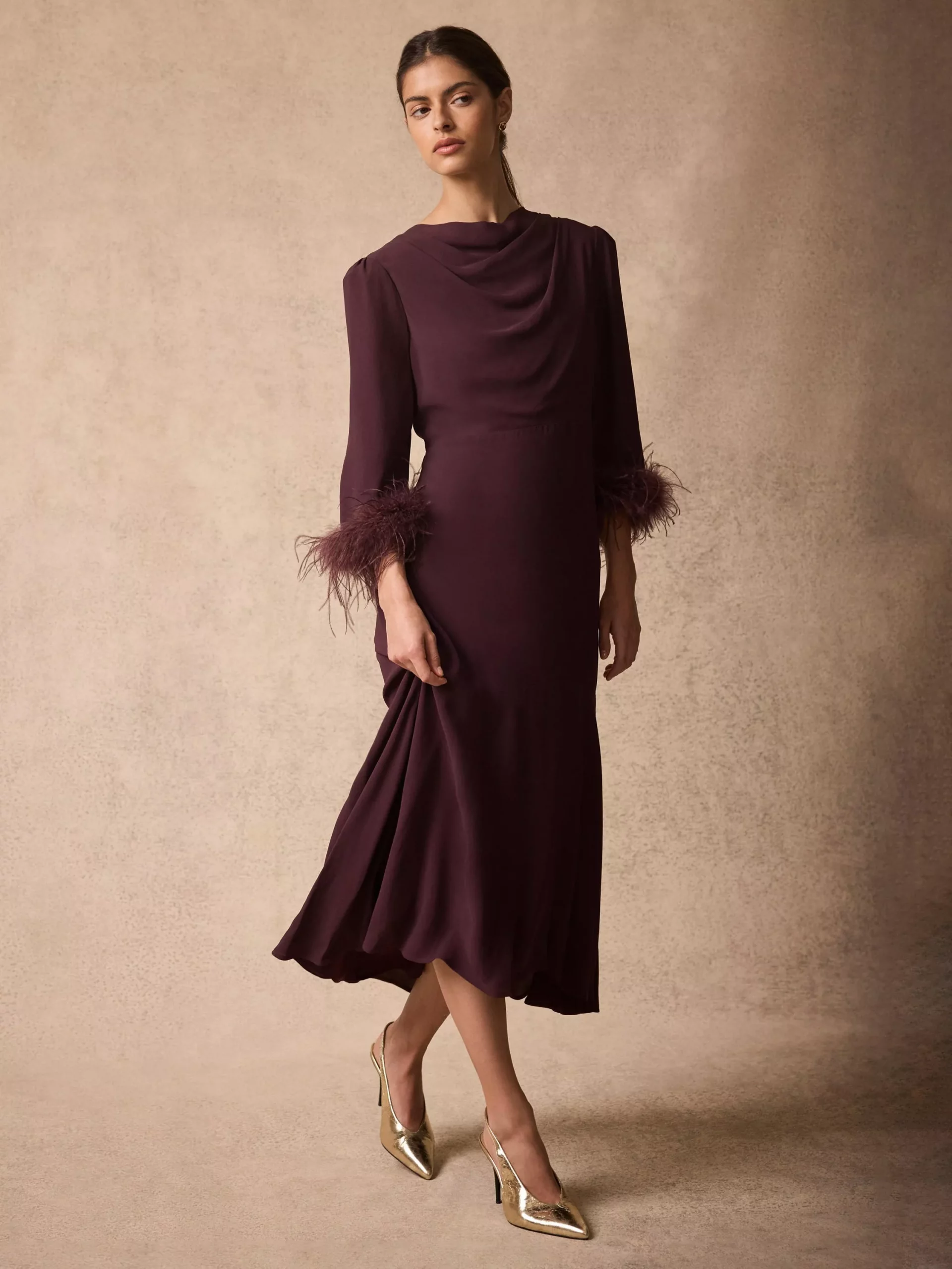 Deep Plum Dress with Feather Cuffs and Draped Neckline — Winter Wedding Guest Outfits