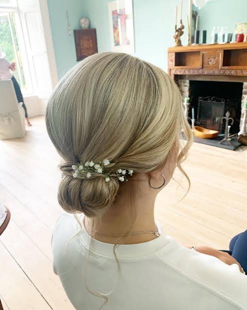 Low Bun With Floral Accents — Winter Party Hairstyles