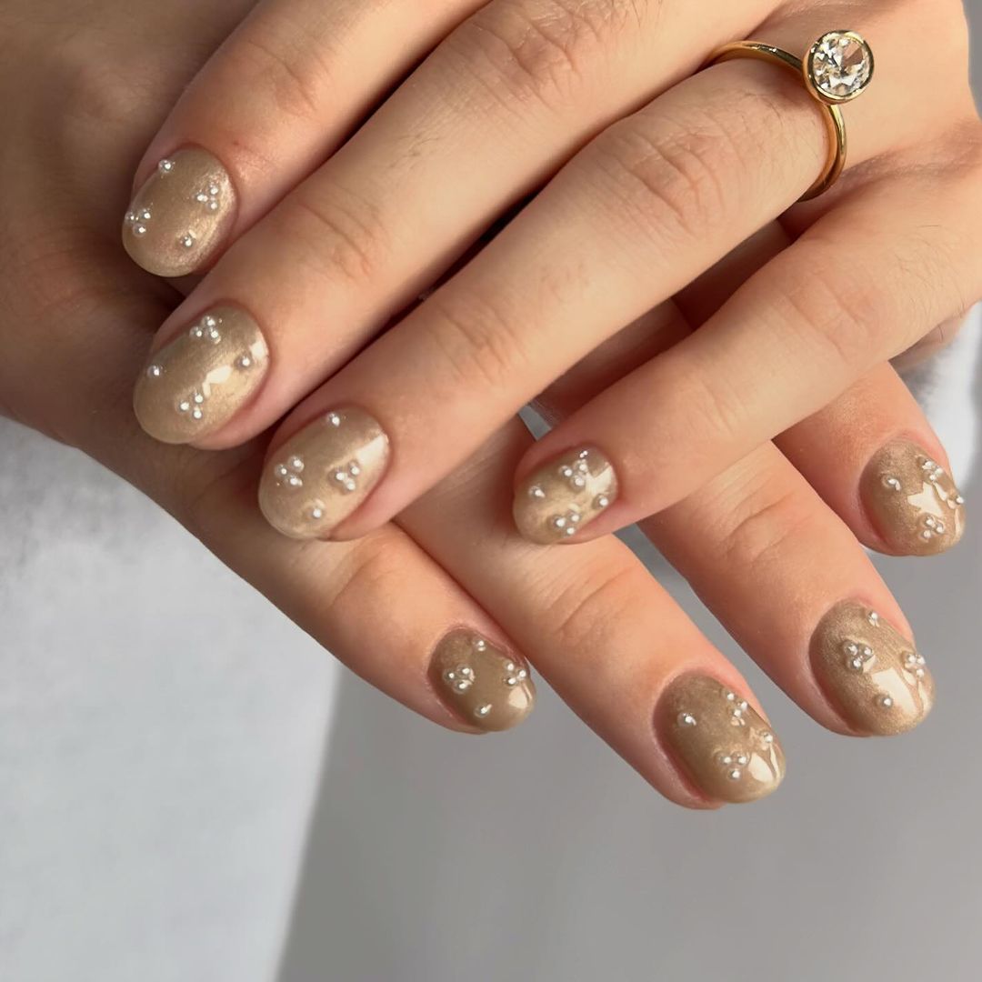 Champagne Shimmer Oval Nails with Pearl Embellishments Champagne Shimmer Oval Nails with Pearl Embellishments — Winter Nail Colors for Women Over 40